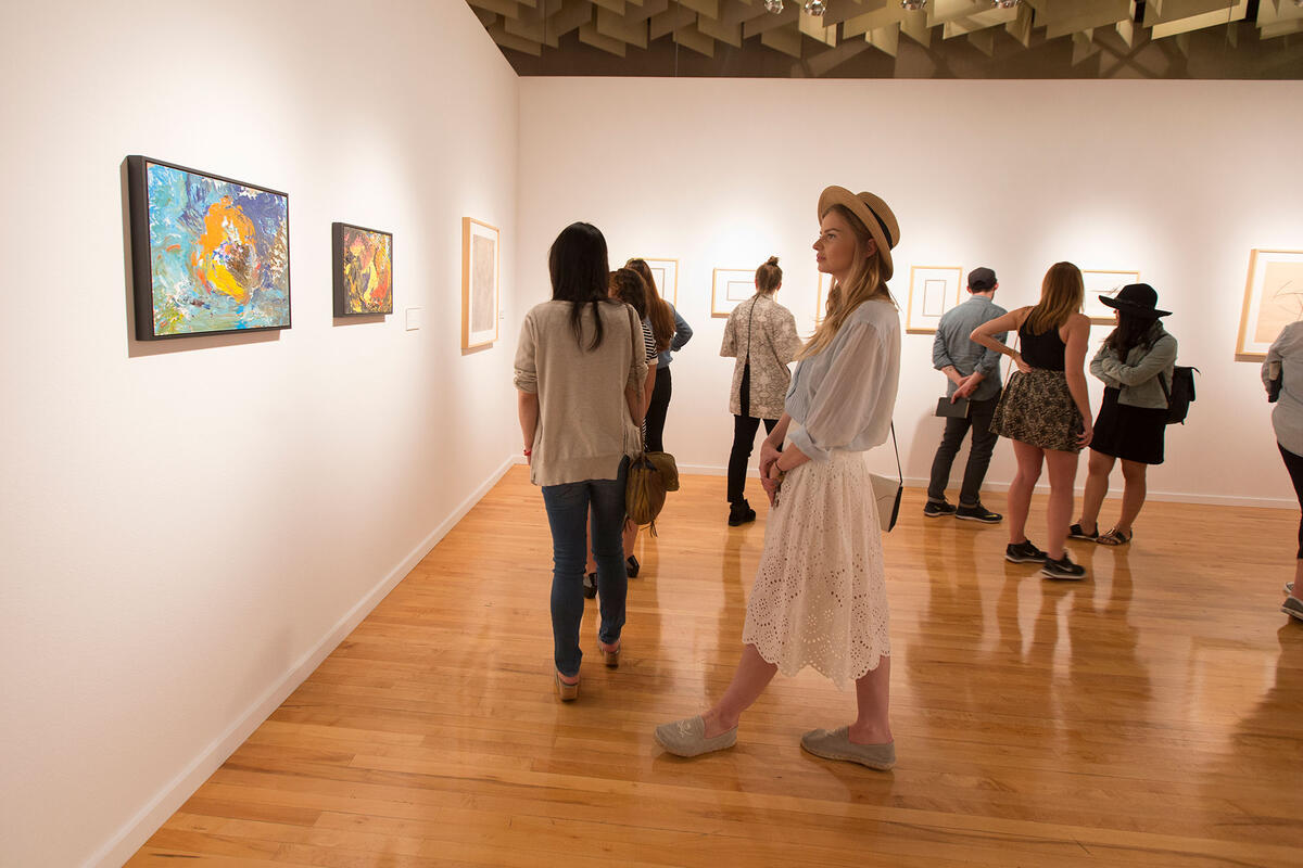 People looking at art pieces