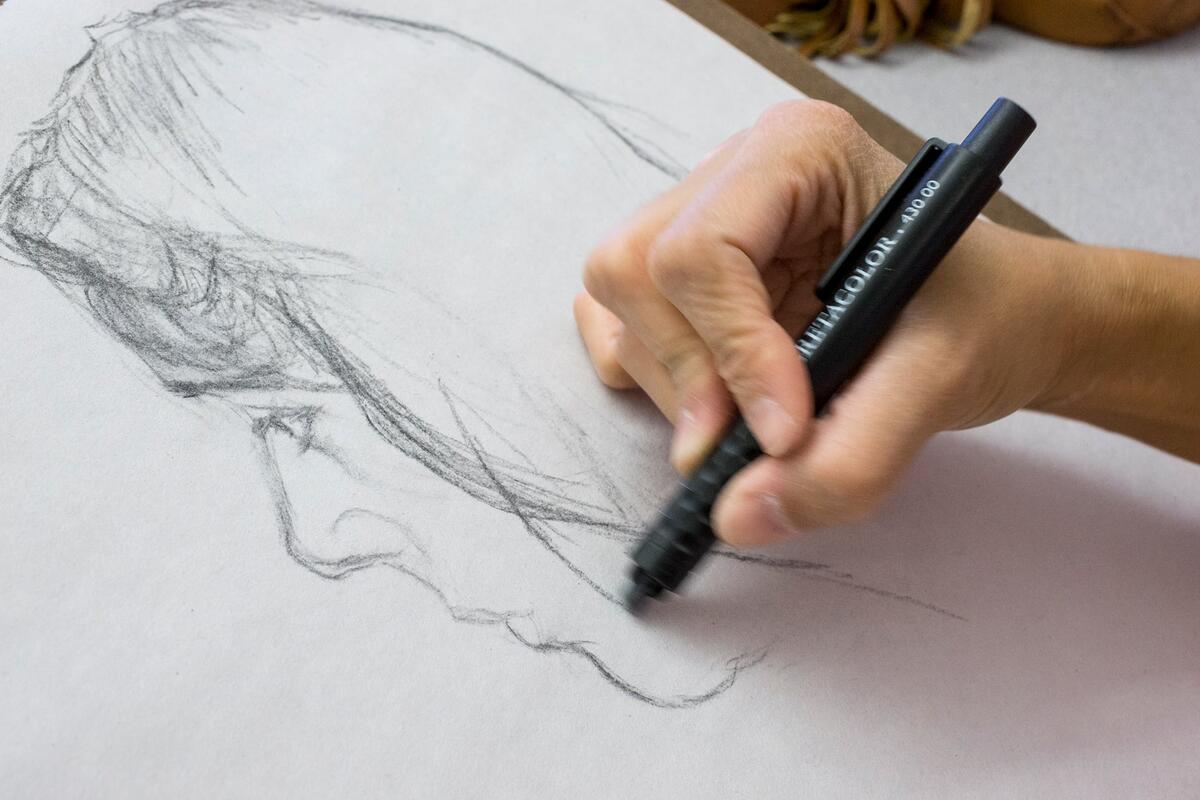 Closeup of a person sketching