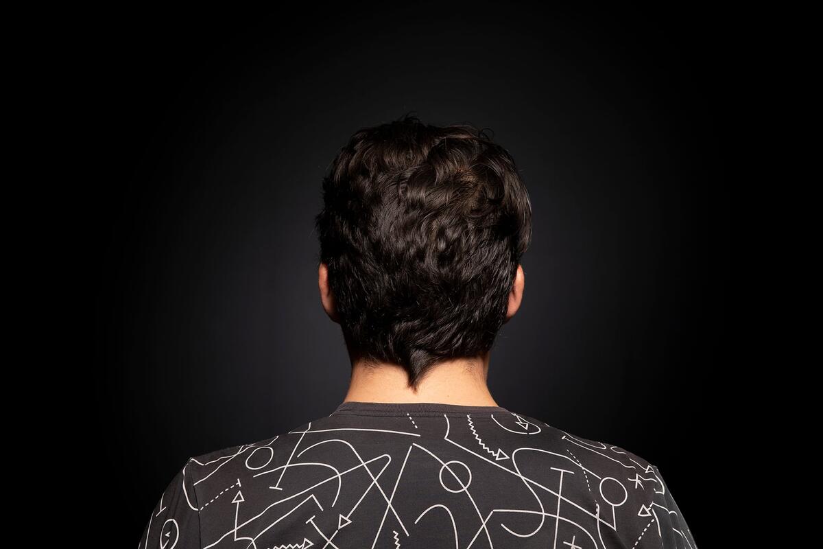 Back of person's head with short wavy brown hair