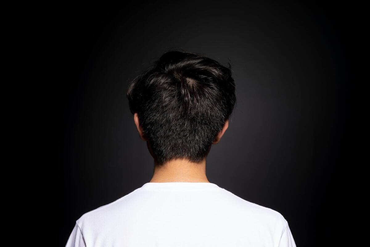 Back of person's head with straight black hair