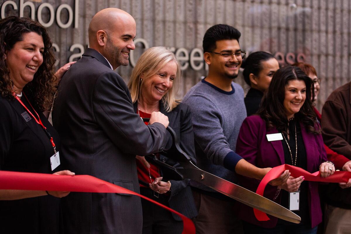 Career and Professional Development staff cutting a ribbon at a ribon cutting ceremony