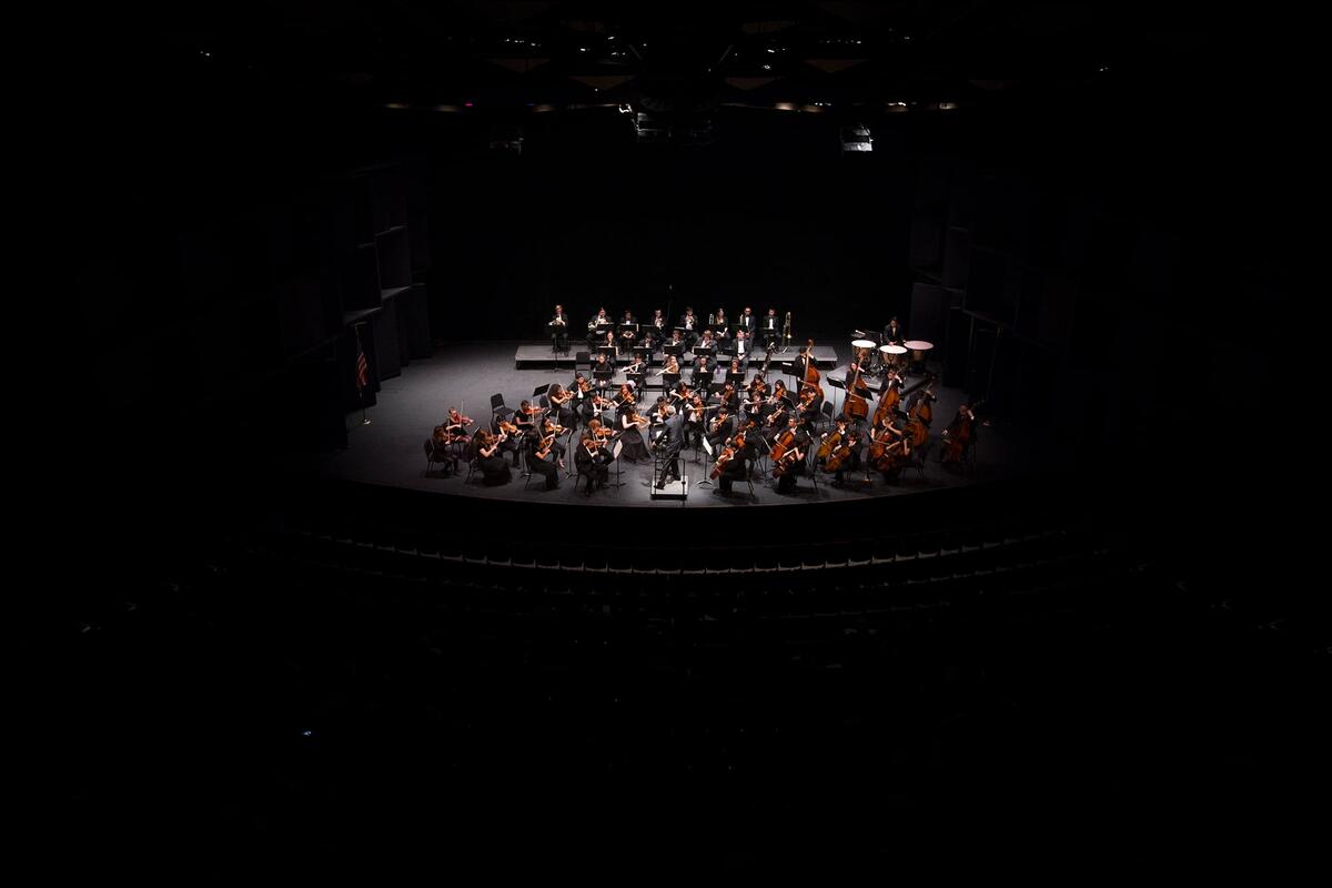 UNLVs orchestra on the stage within the concert hall.