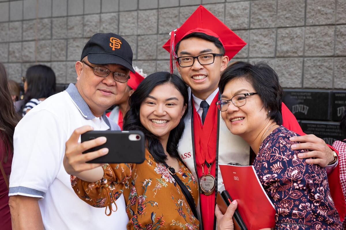 Family taking a selfie with the U-N-L-V graduate