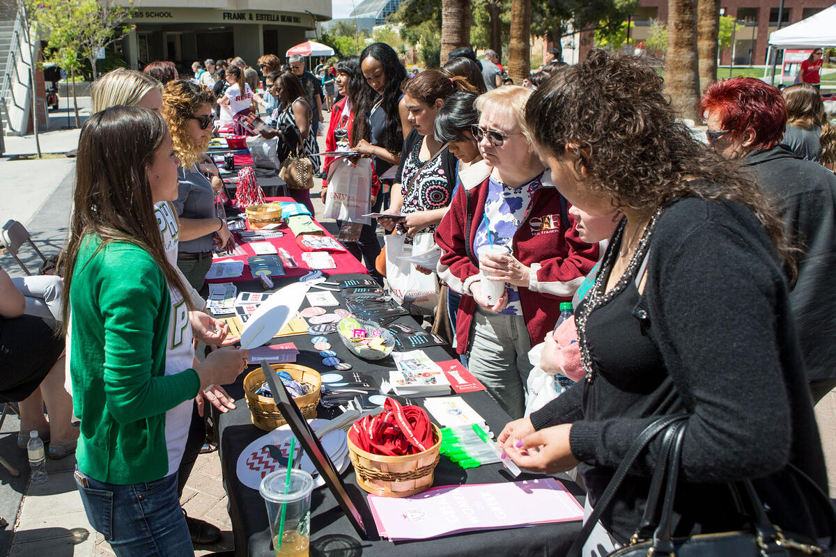 People gathering around a student organization booth