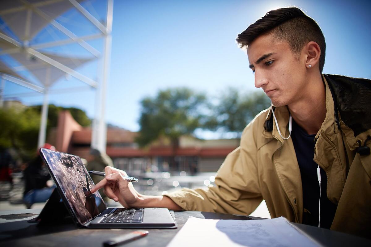 Student working on a laptop outside