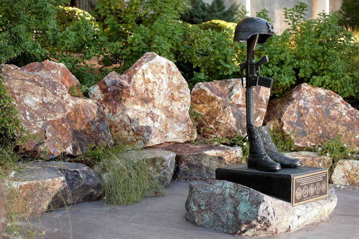 Bronze sculpture Of military helmet, rifle, and boots