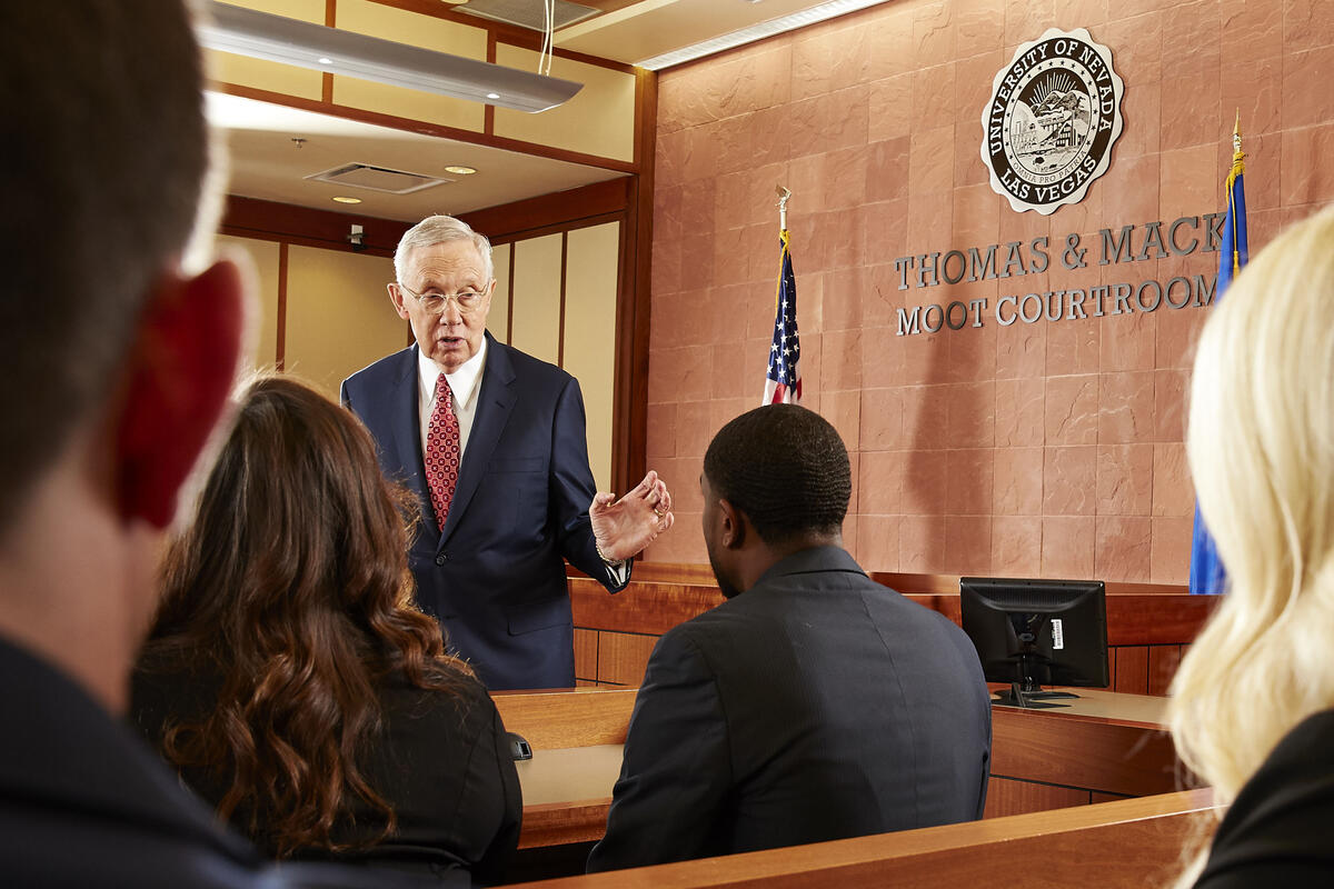 man in courtroom setting talking to group