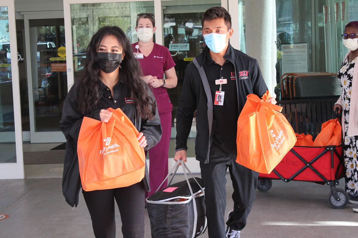 People with masks holding bags.