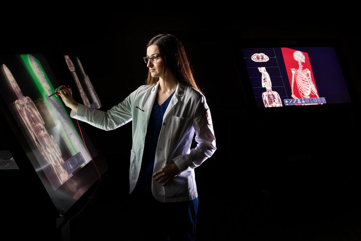 A student working on an interactive x-ray of a body.