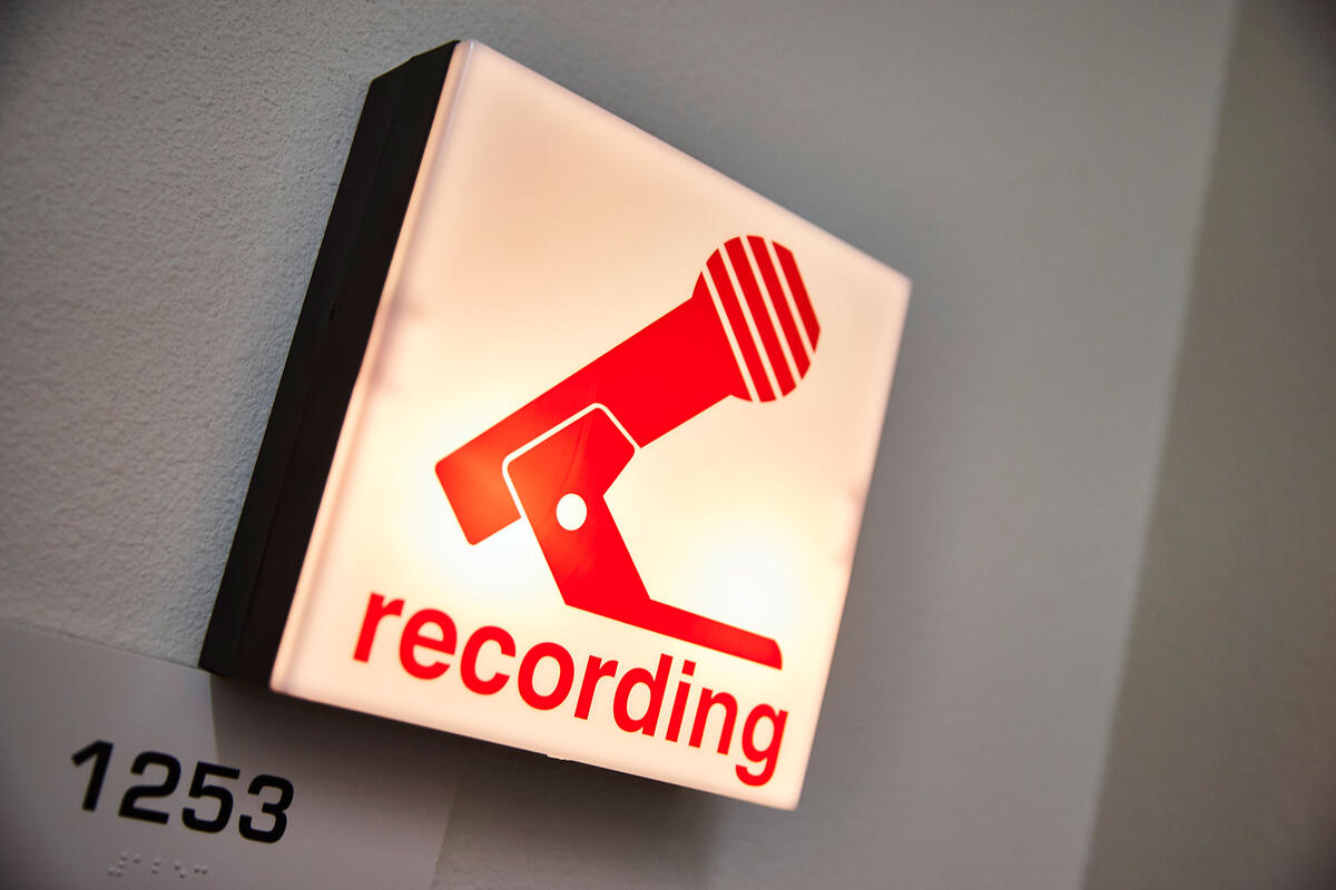 A "recording" sign with a microphone icon.