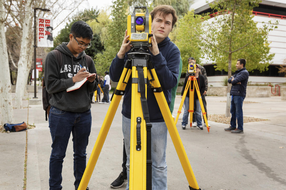 engineering students surveying on campus