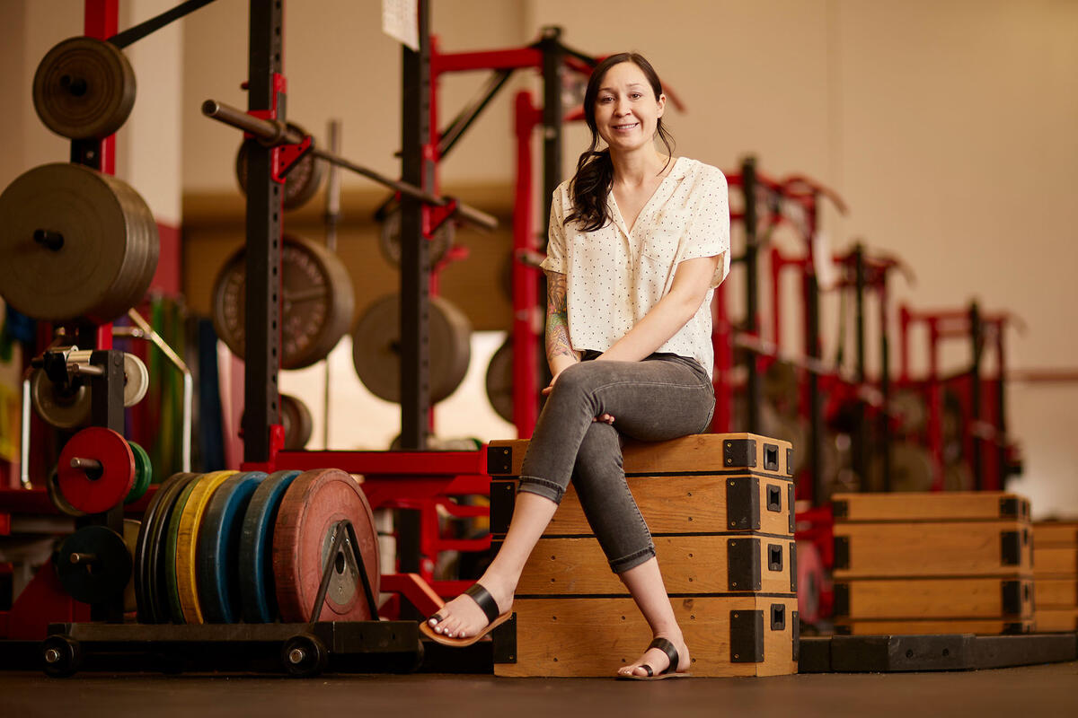 woman seated in weight gym