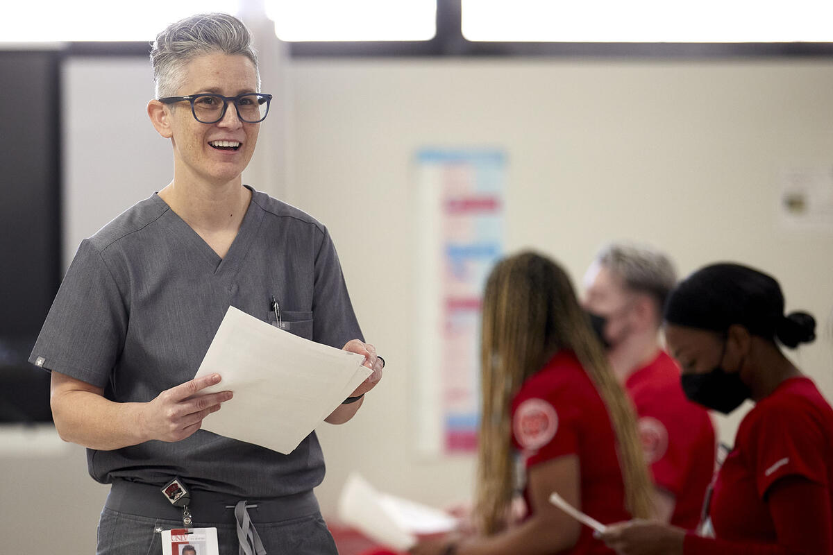 woman in nursing scrubs in classroom setting