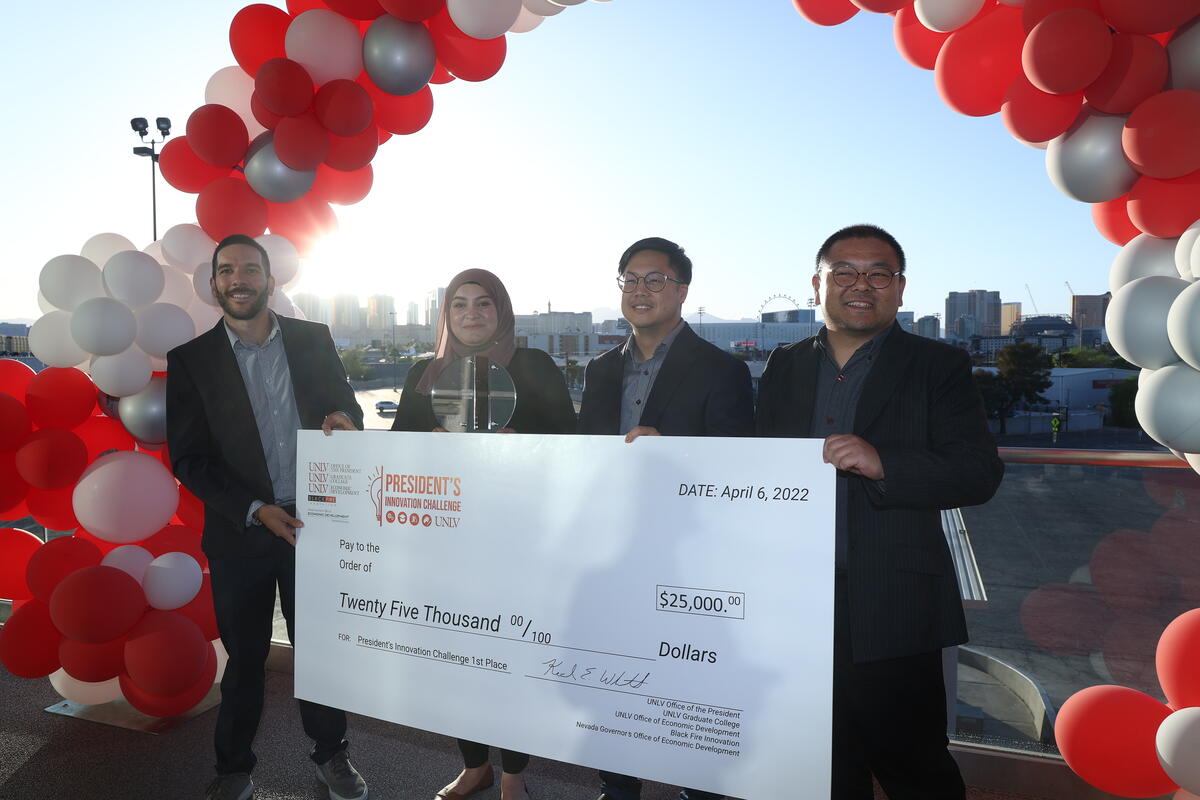 UNLV students pose with check after winning innovation challenge