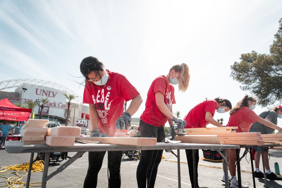 Four students work at a station cutting wood.