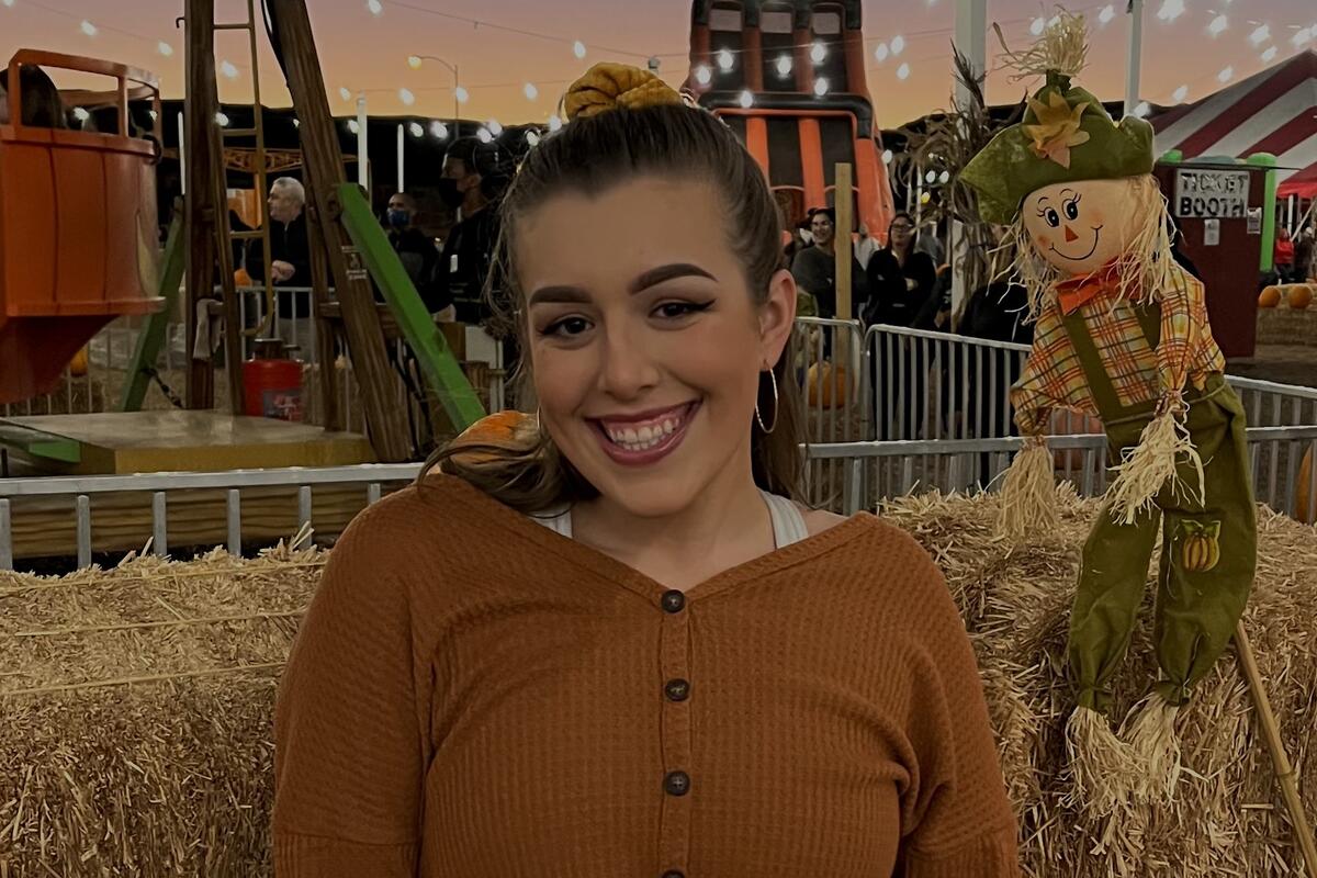 Savvy Miller smiles at a pumpkin patch. 