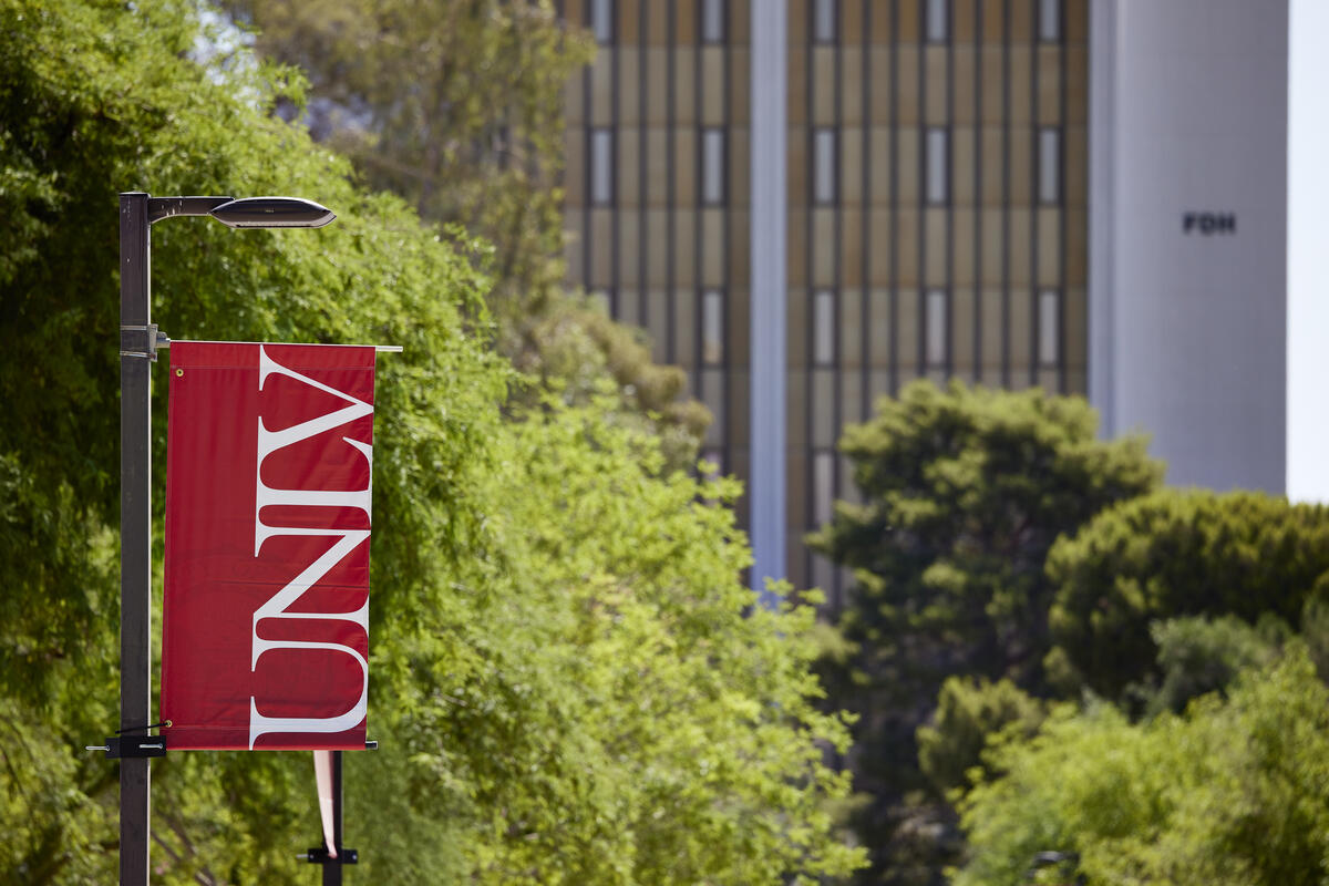 View of UNLV banner with campus building in background