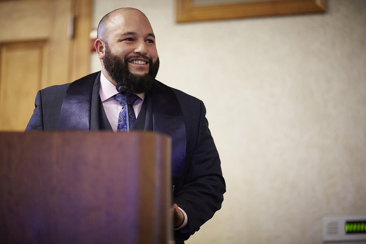 Man at a podium smiling