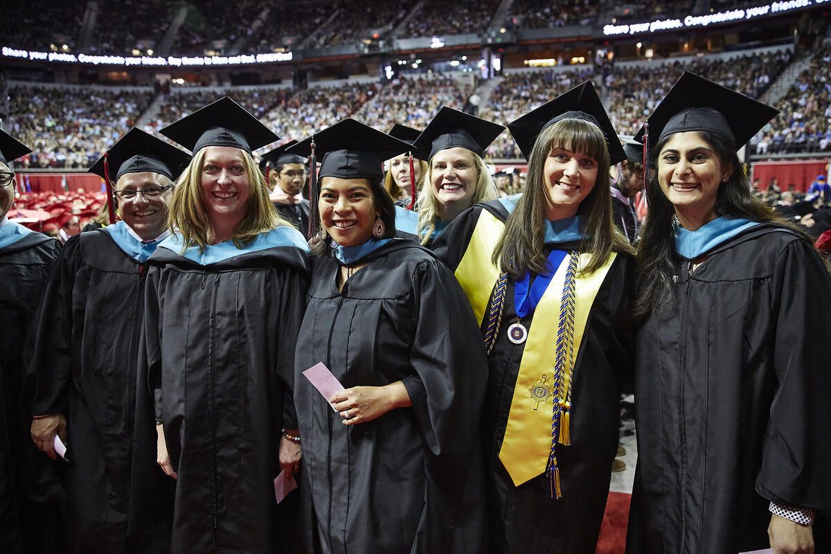 Group of graduates at commencement posing for a picture