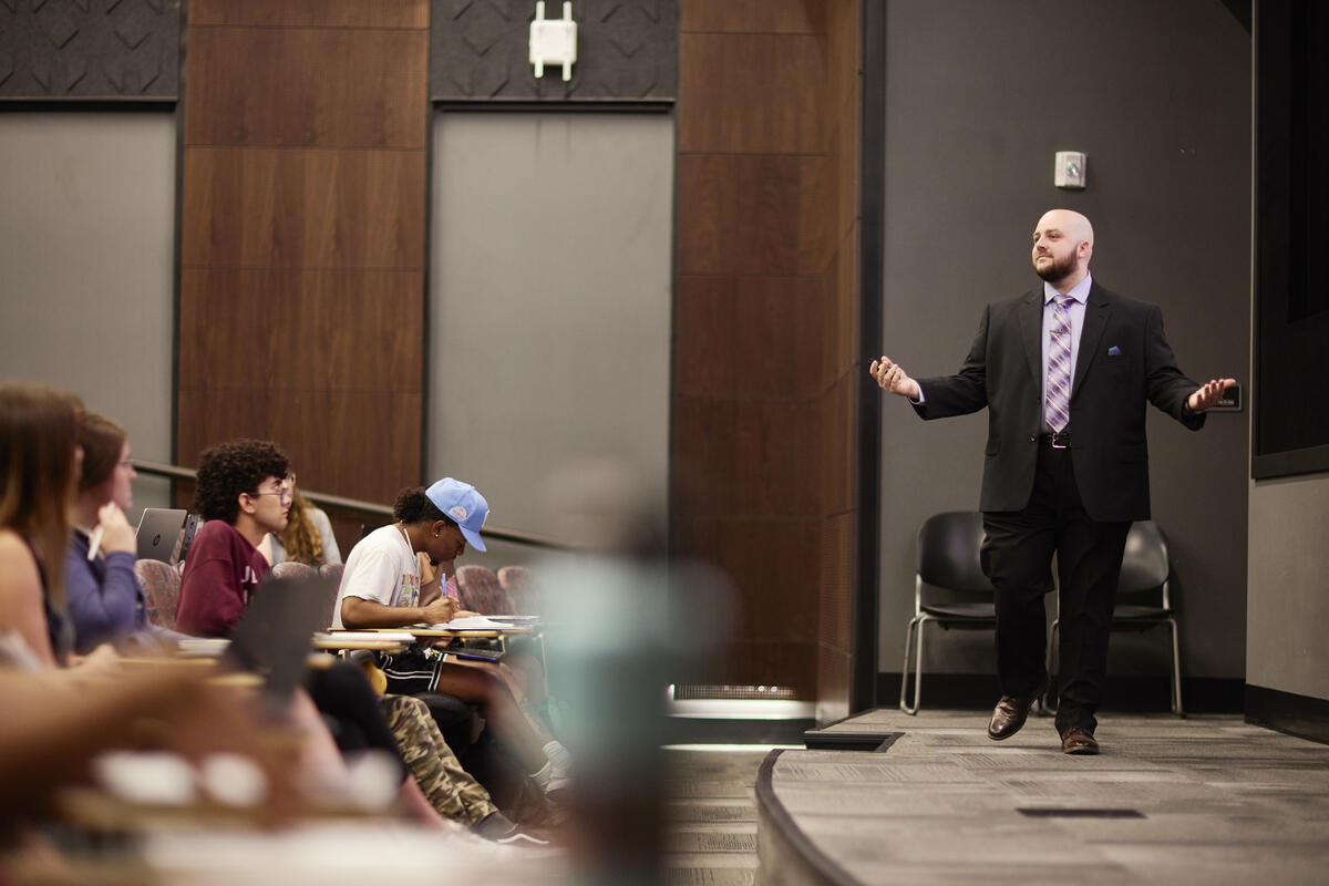 man teaching in front of classroom