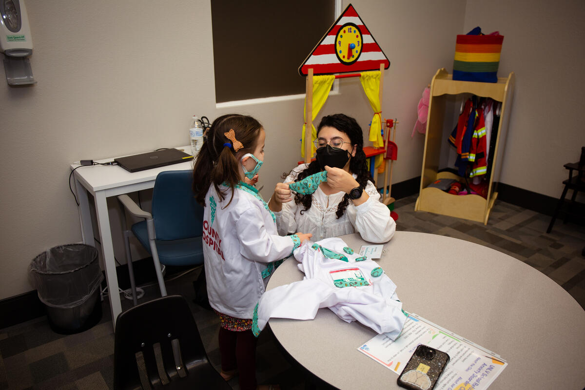 adult working with a child during a session