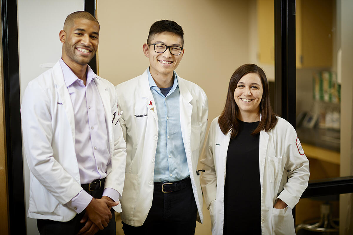 Faun Botor (right) alongside fellow charter class graduates Damien Medrano (left) and Toyokazu “Chris” Endo (center).