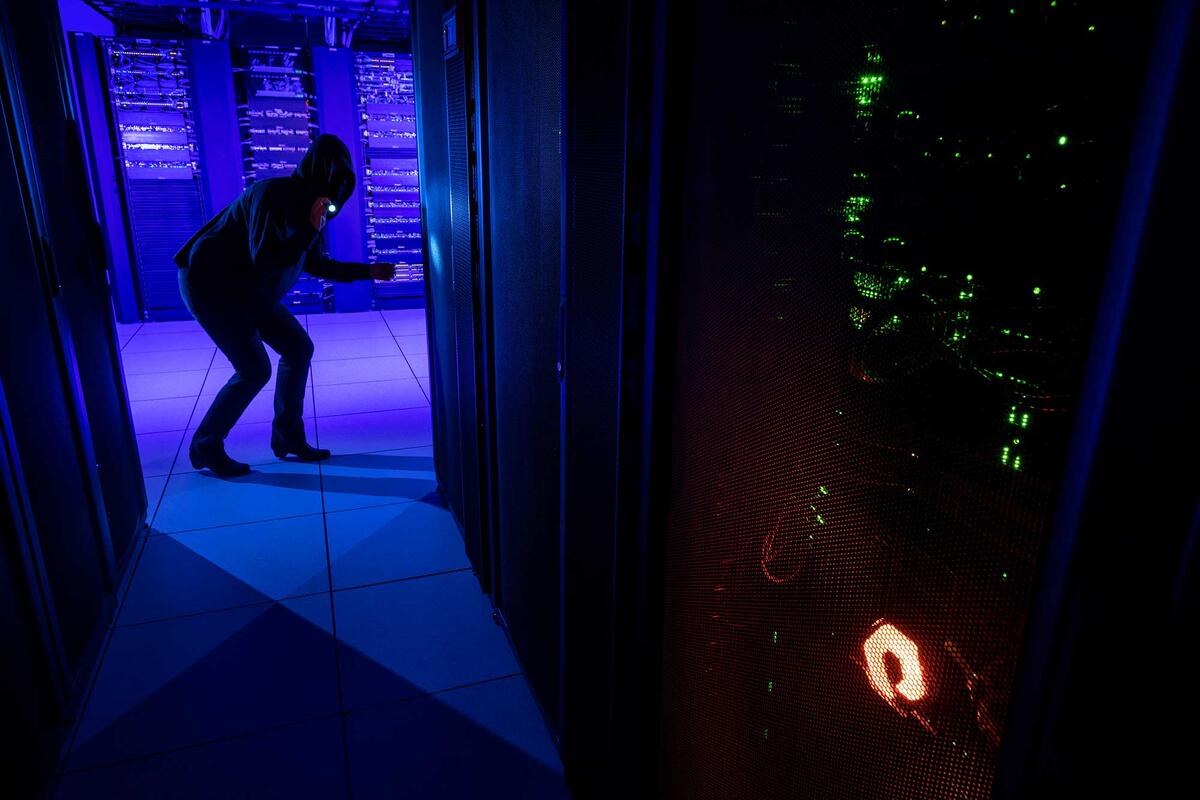 Silhouette of a person working at a mainframe