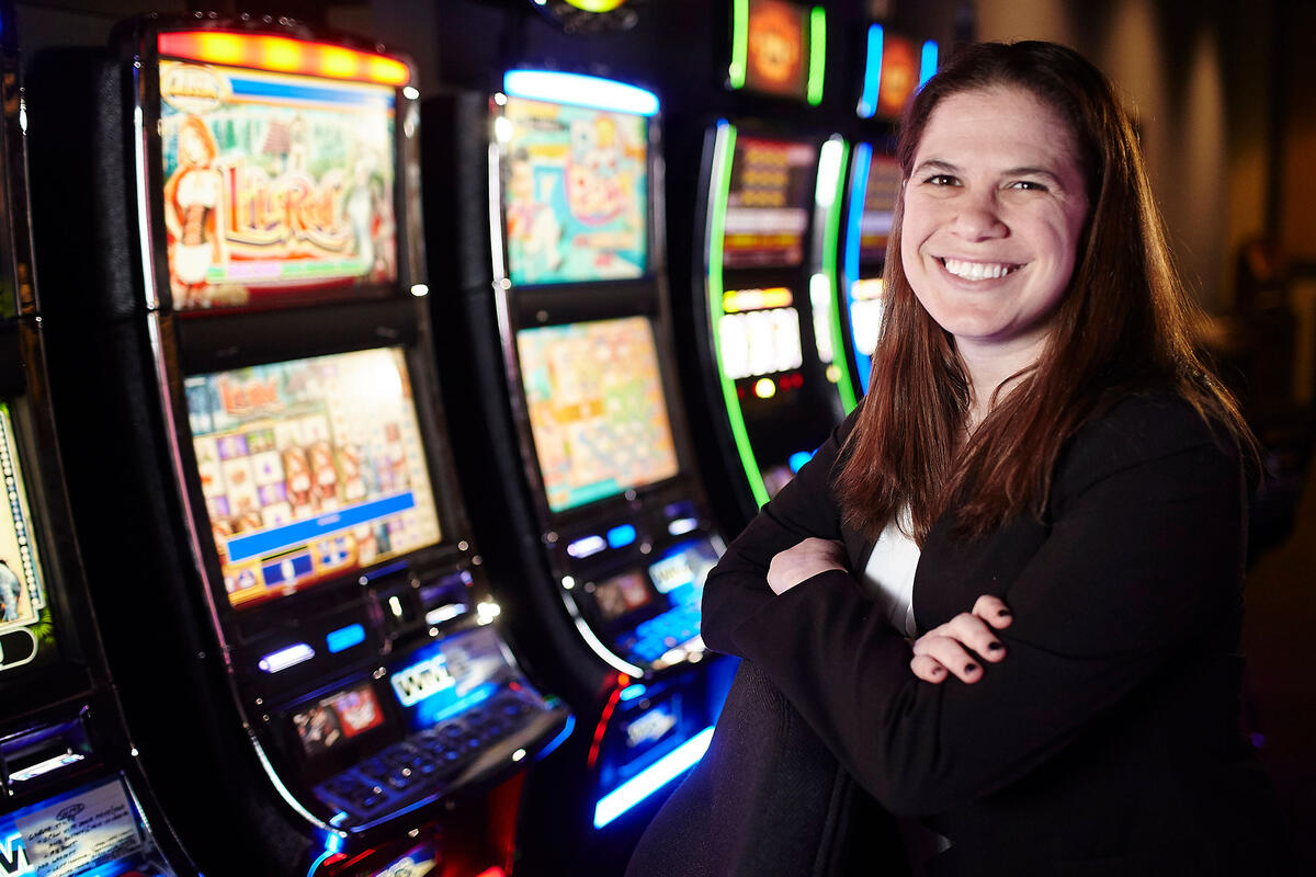A woman crossing her arms in front of a slot machine