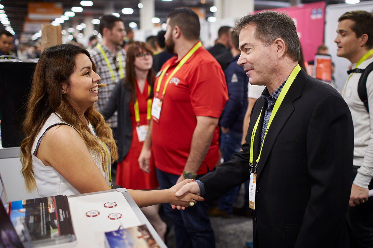 Engineering student Michelle Mata shaking hands with former U-N-L-V President Len Jessup
