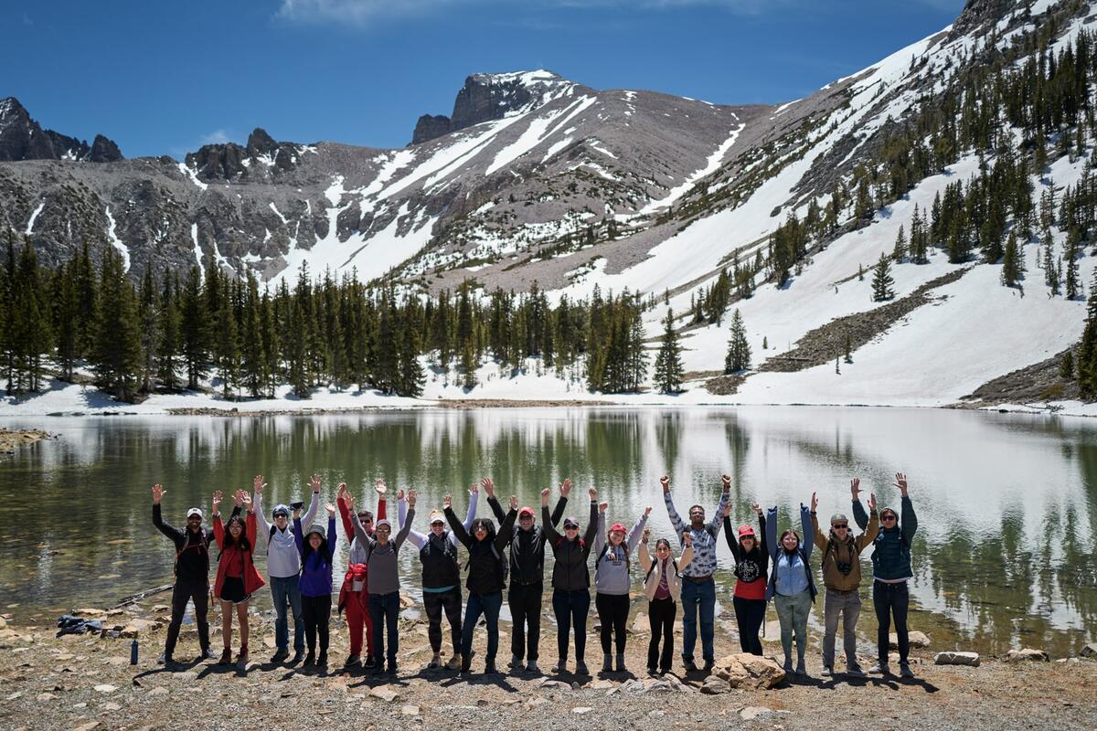 Students posing in front of snowy mountains