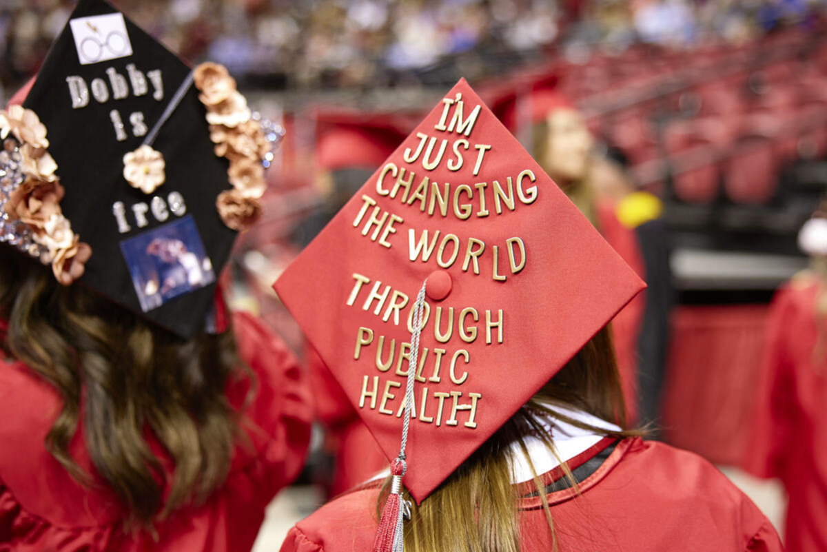 Graduation cap with phrase "I'm just changing the world through public health" on top