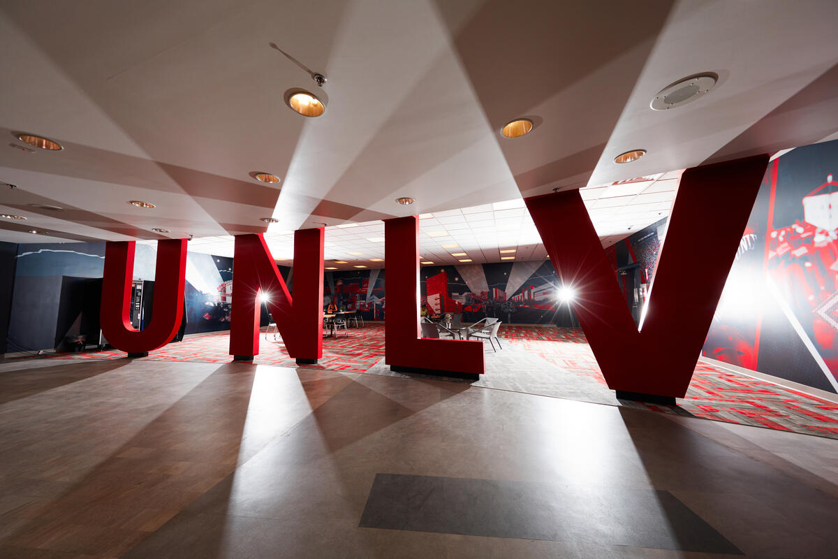large UNLV letters in a backlit room