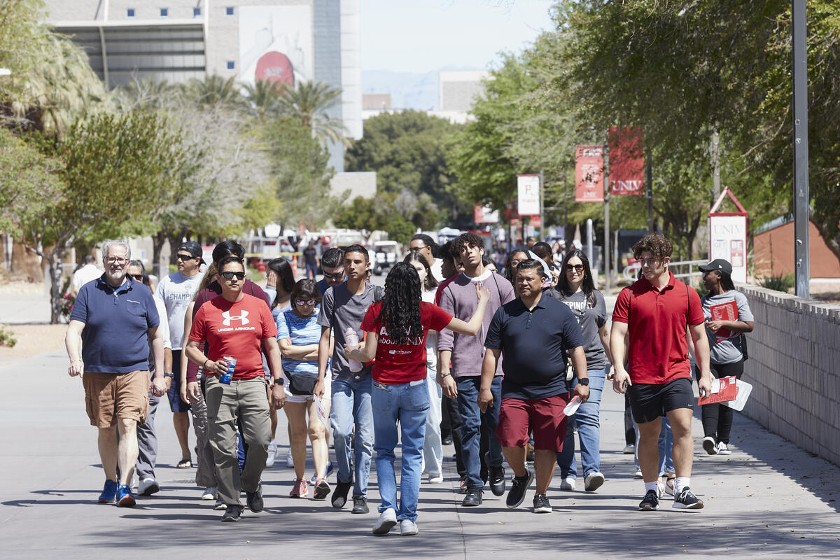 A tour guide showing people around the UNLV campus
