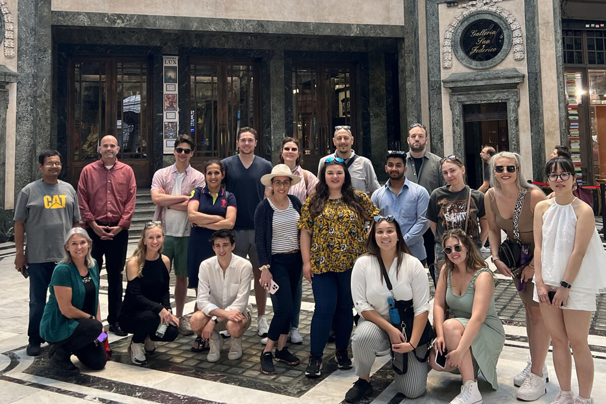 group of student posing in front of Italian business