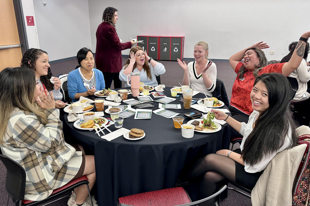 people in a circular table with different reactions