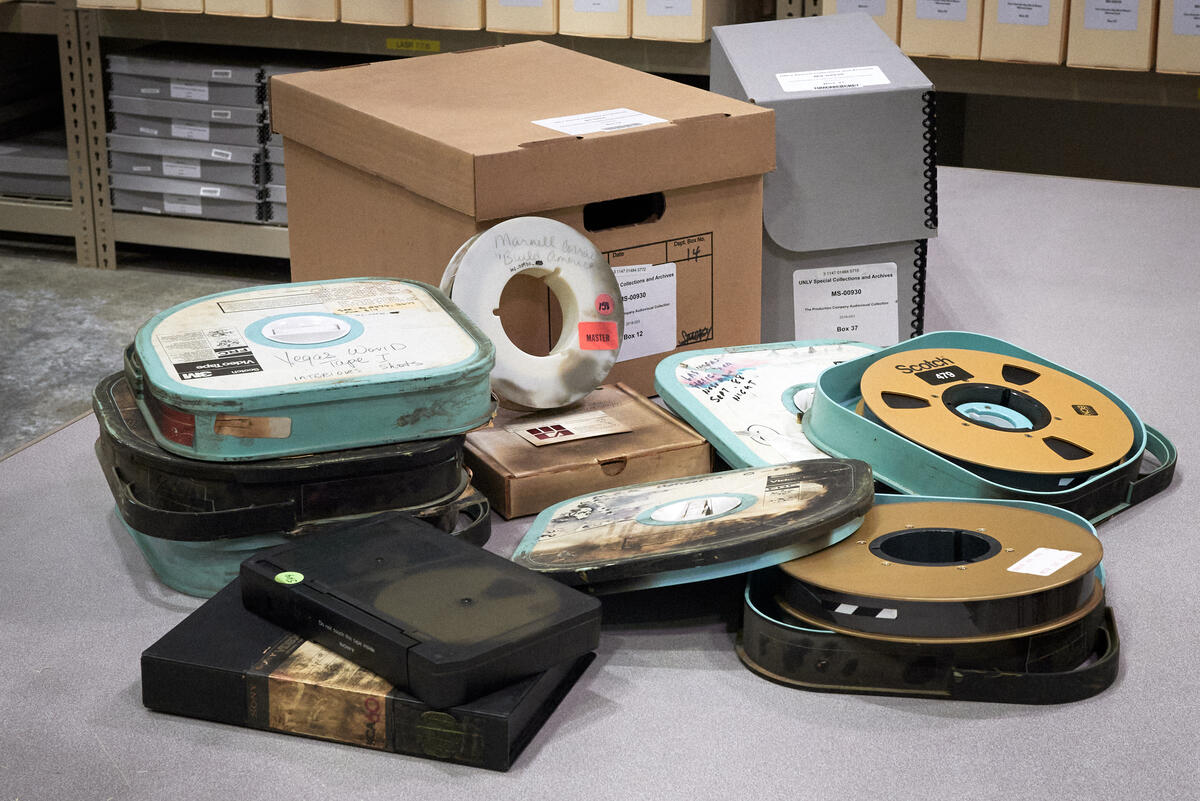 Singed film reels and other recordings displayed on the ground