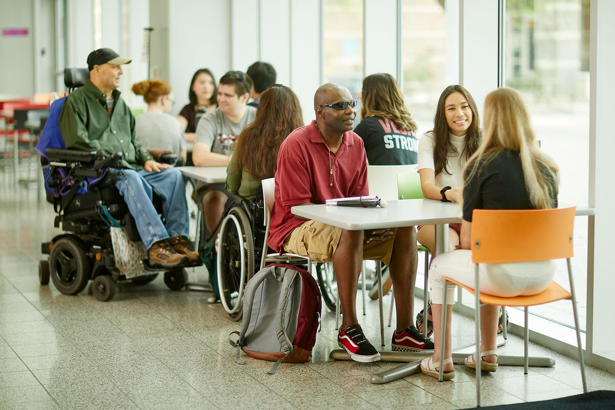 A diverse group of people sitting down at tables