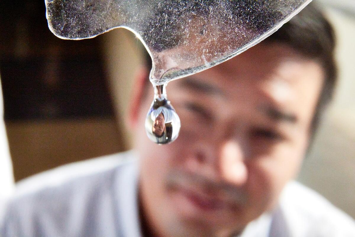Professor looks at drop of water falling from ice