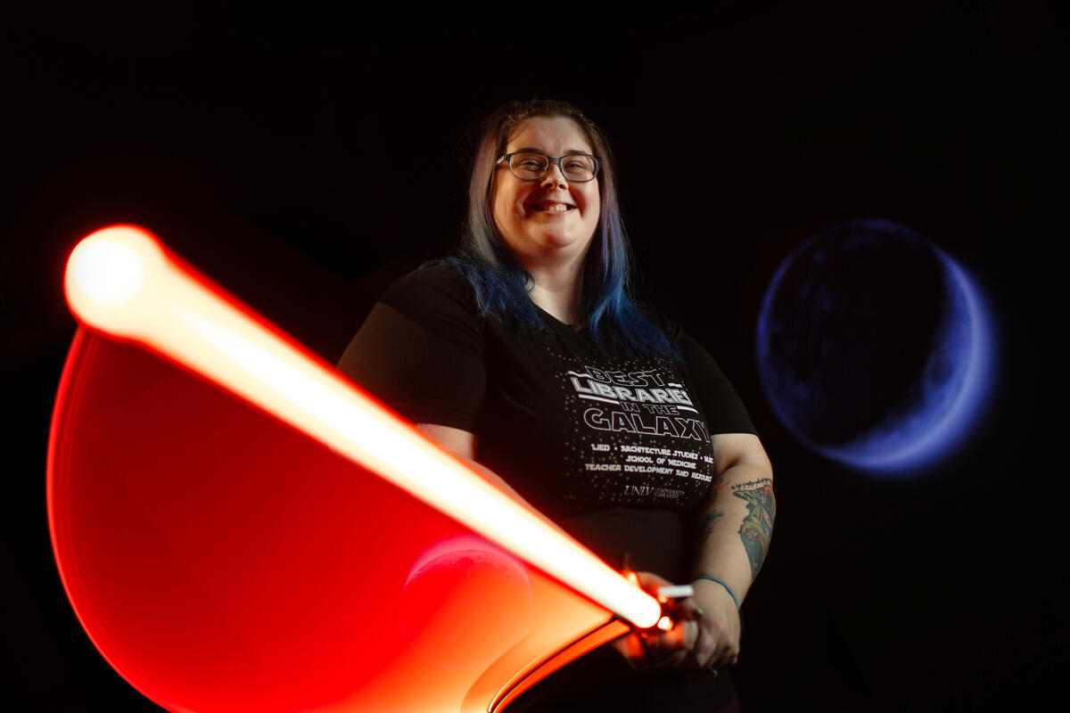 individual swinging a red light saber with a glowing photo effect