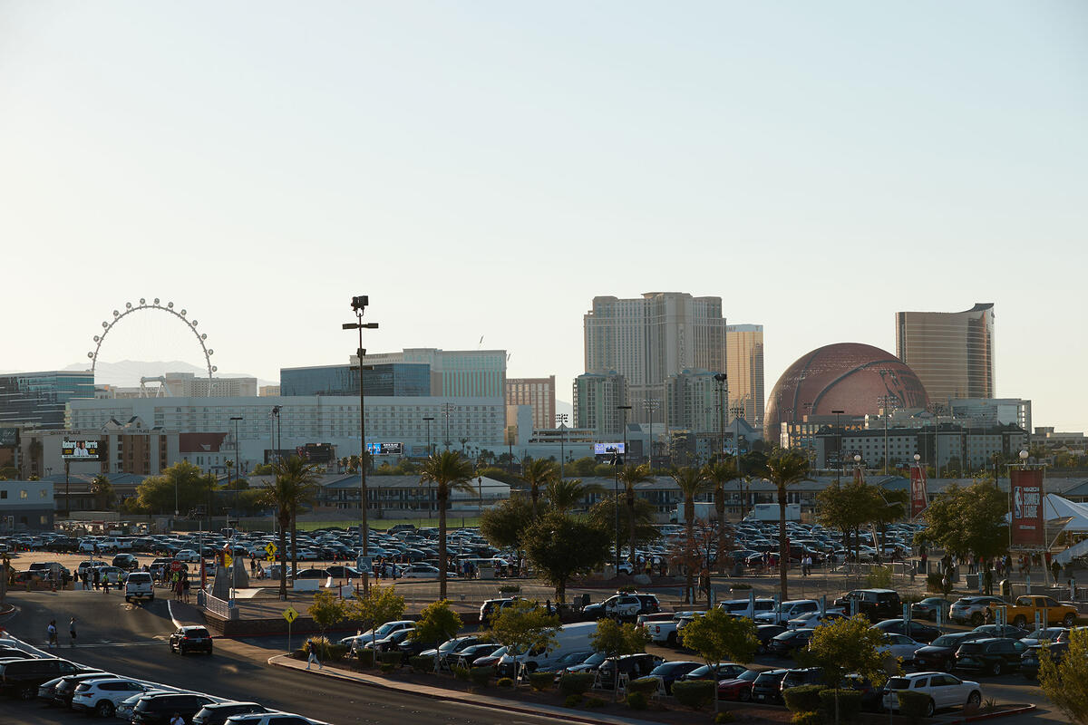 A parking lot with the Sphere and Las Vegas strip in the background