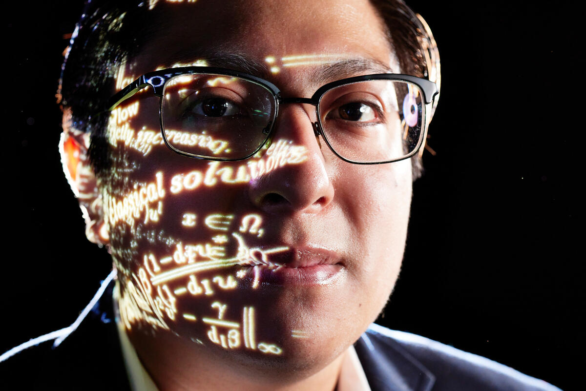 illustration of man wearing glasses with half of his face covered in equations