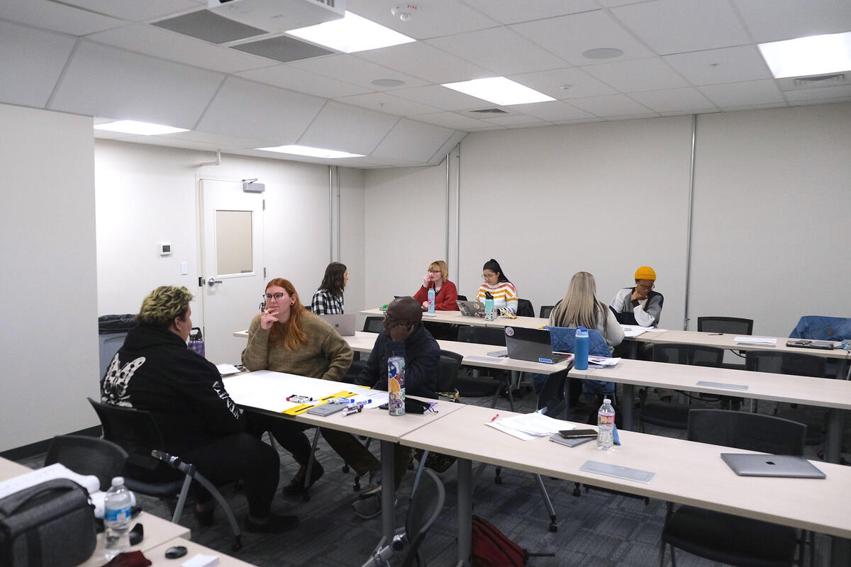 college students doing group discussions in classroom