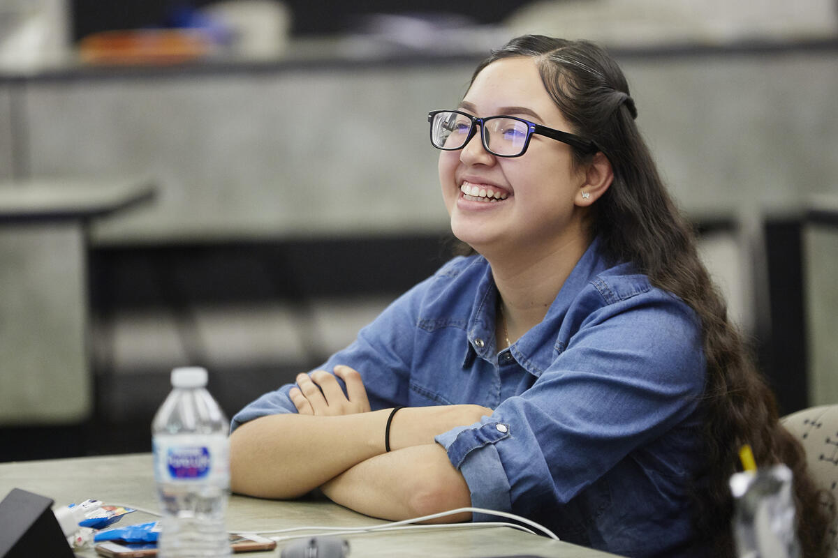 Person sitting at desk smiling
