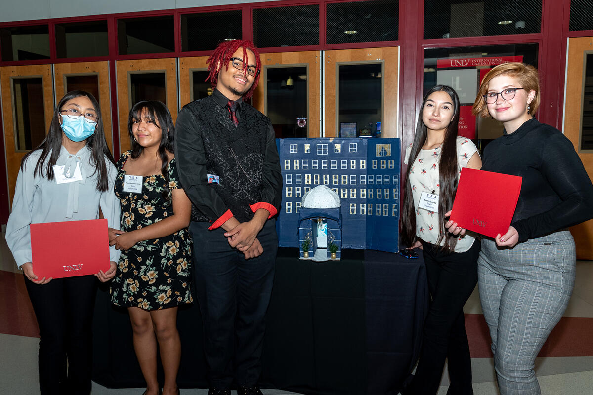 Group of students standing in front of demonstration table