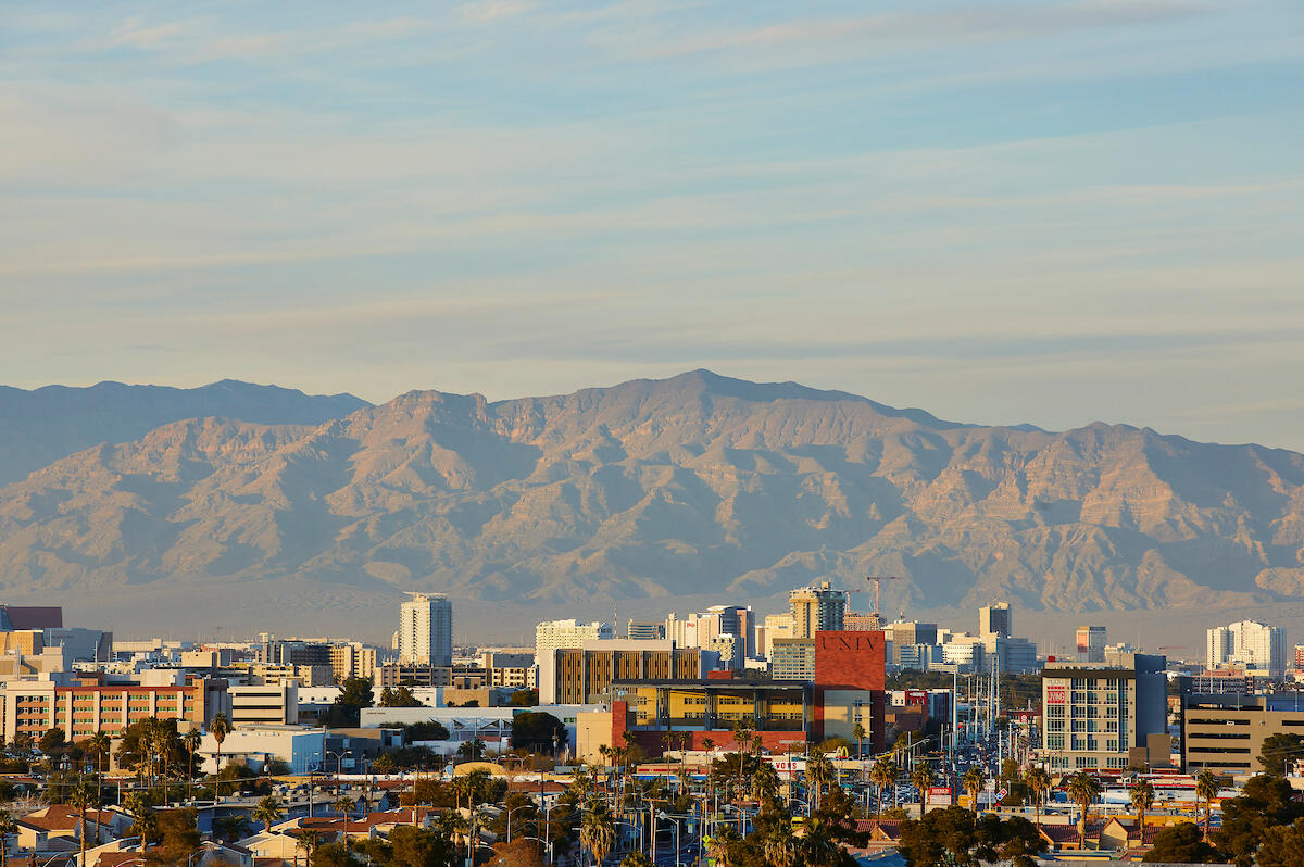 Wide shot of the Las Vegas valley with the UNLV Greenspun Hall sign in the center.
