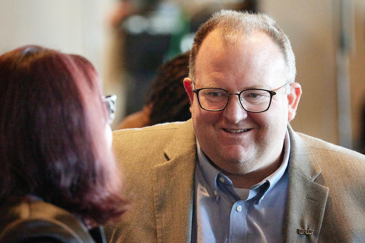 candid of man in suit jacket talking to a woman