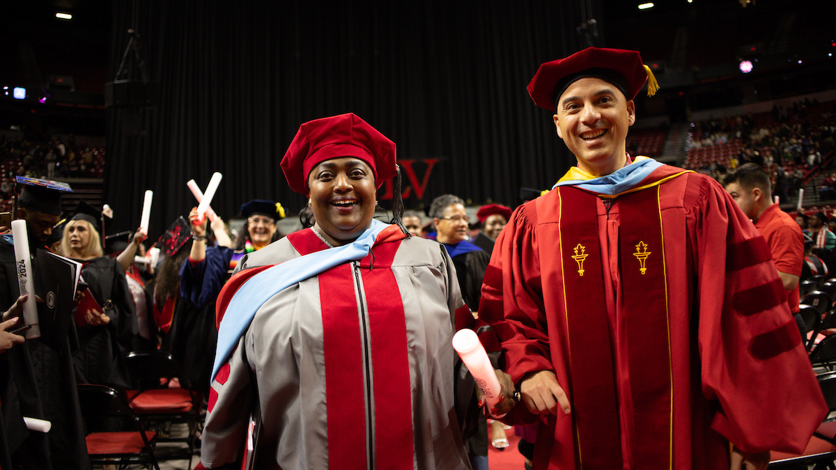 Brooks and Gonazales participating in a graduation ceremony