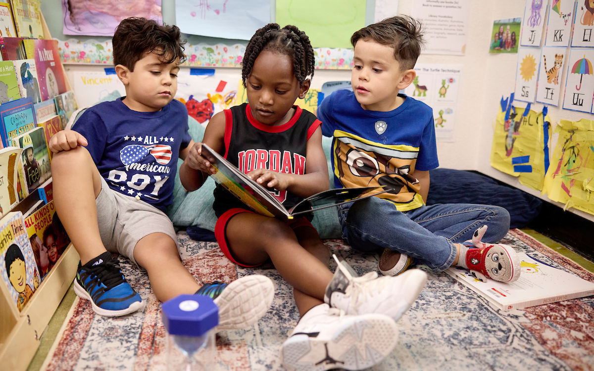 Preschool Children reading together in a reading corner