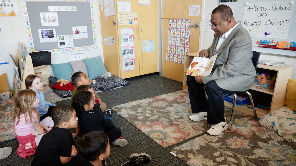 Keith Whitfield (President of UNLV) reading to preschool students during Whitfield Reading Week