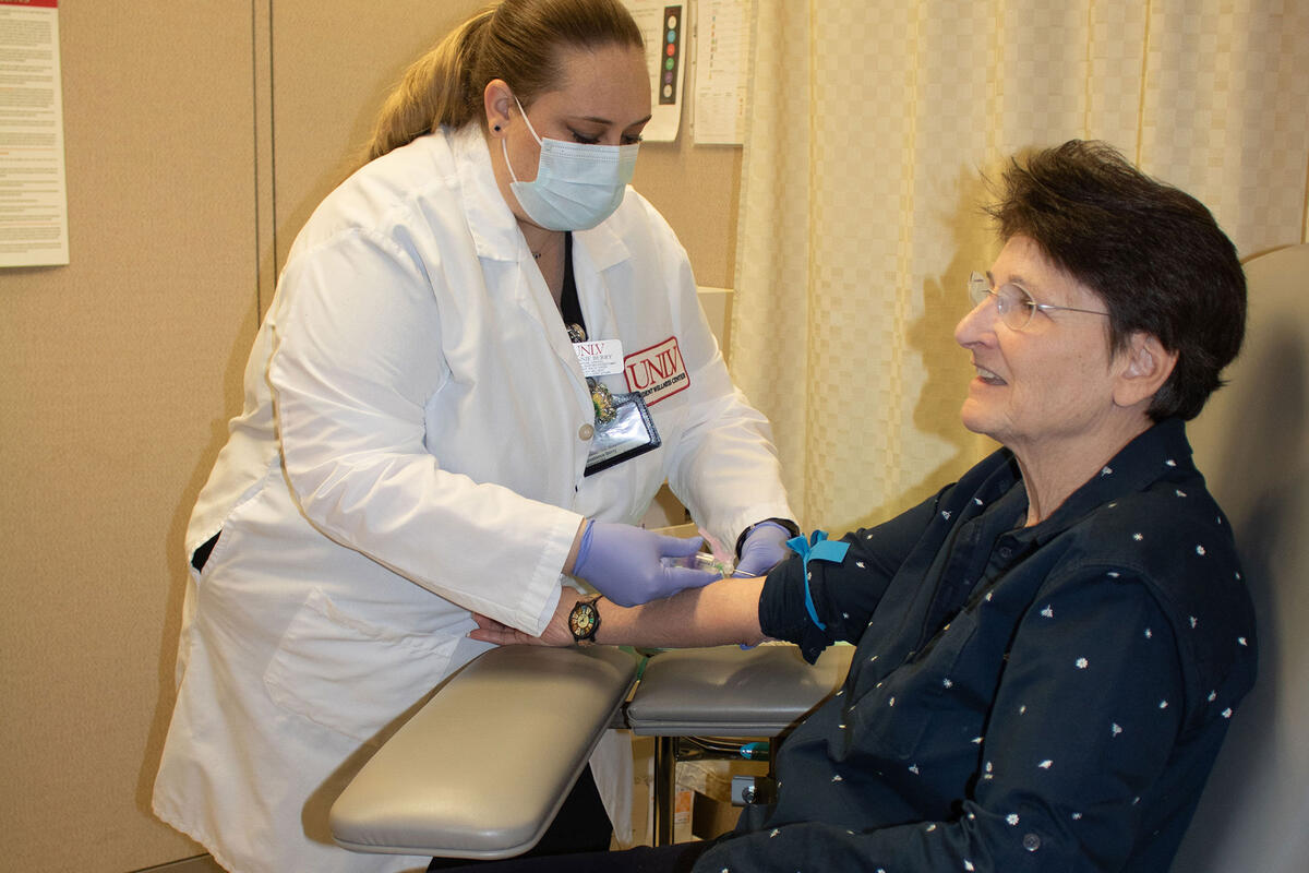 A patient getting their blood drawn from a nurse